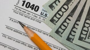 Tax Forms With Pencil and Dollars