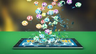 A tablet with lottery balls falling out of it